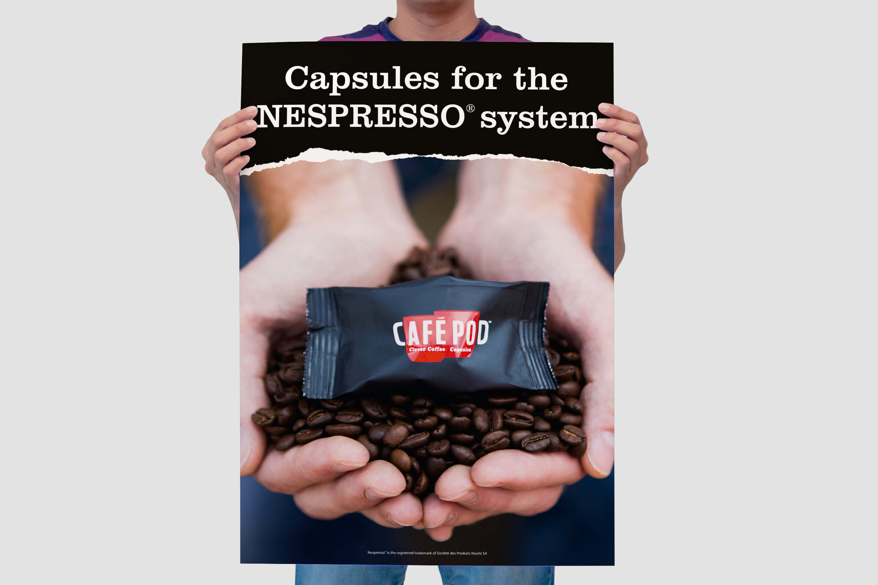 Man holding a CaféPod trade show poster design