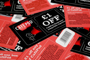 Close up of multiple CaféPod vouchers mixed up and showing both front and back design