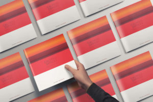 A man holding a printed edition of an interactive brochure