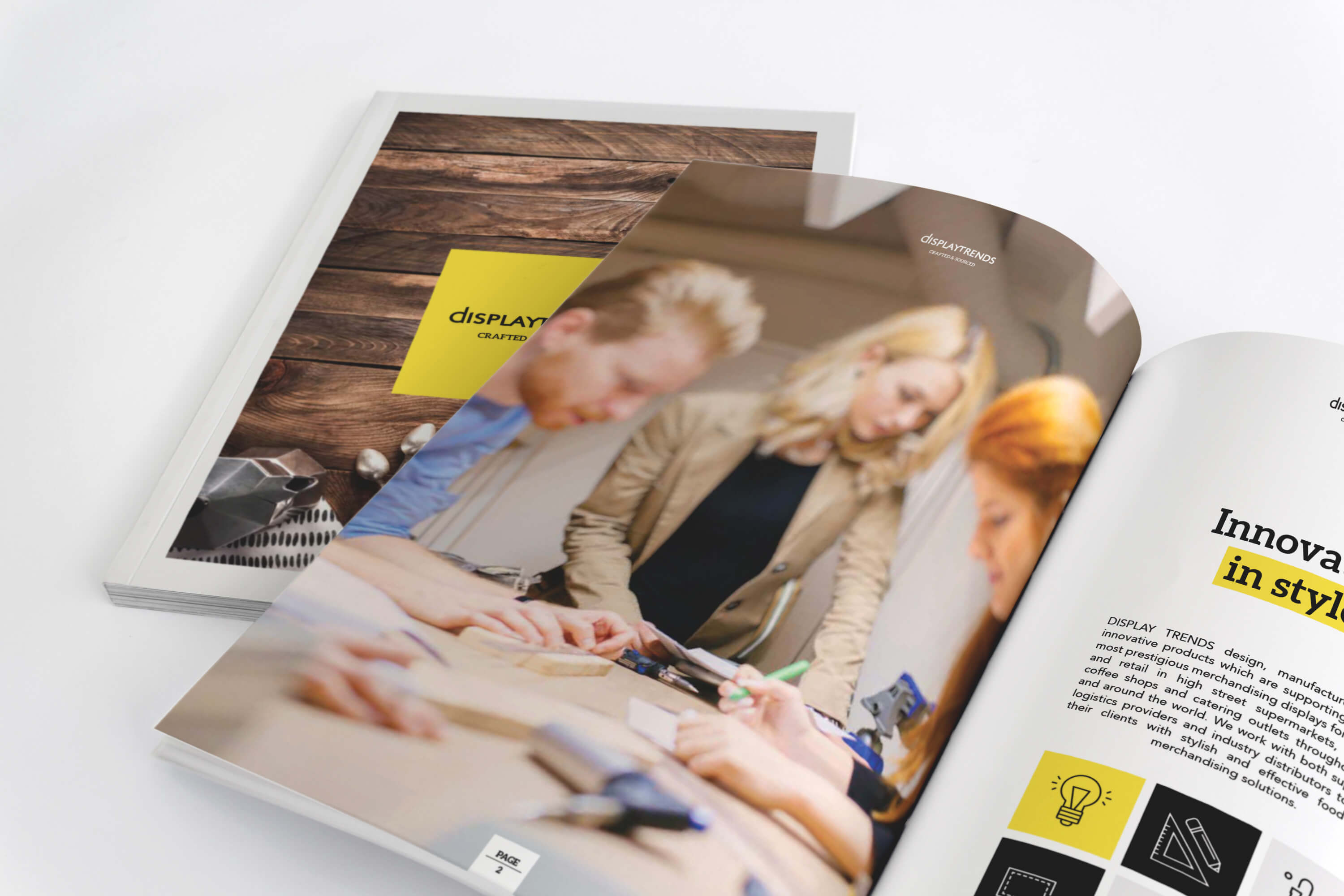 Two Display Trends catalogues on a desk, one on top and open, the other closed underneath