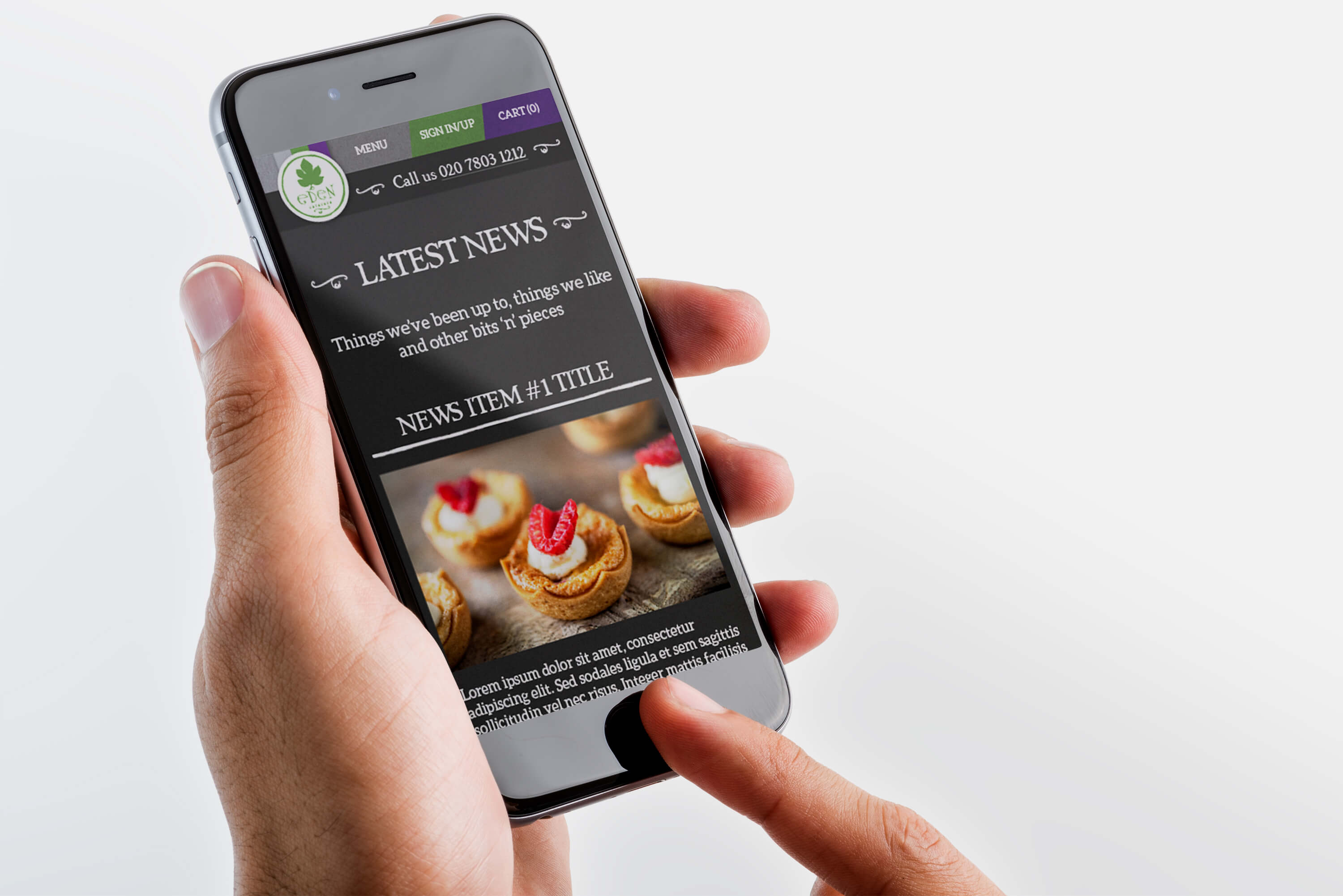 Holding an iPhone displaying the Eden Caterers news page design