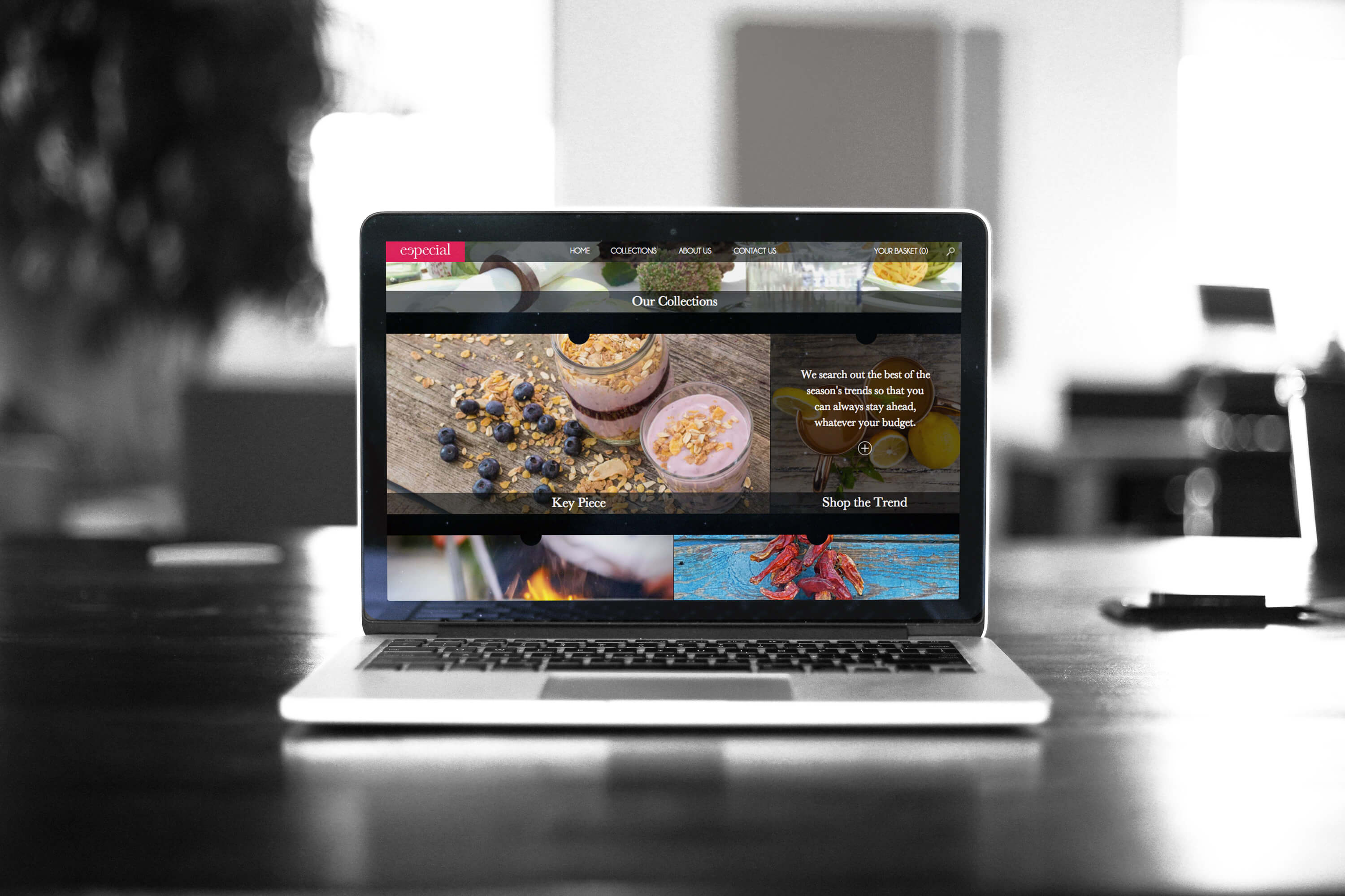 A laptop on a desk showing a section of the Especial website home page design