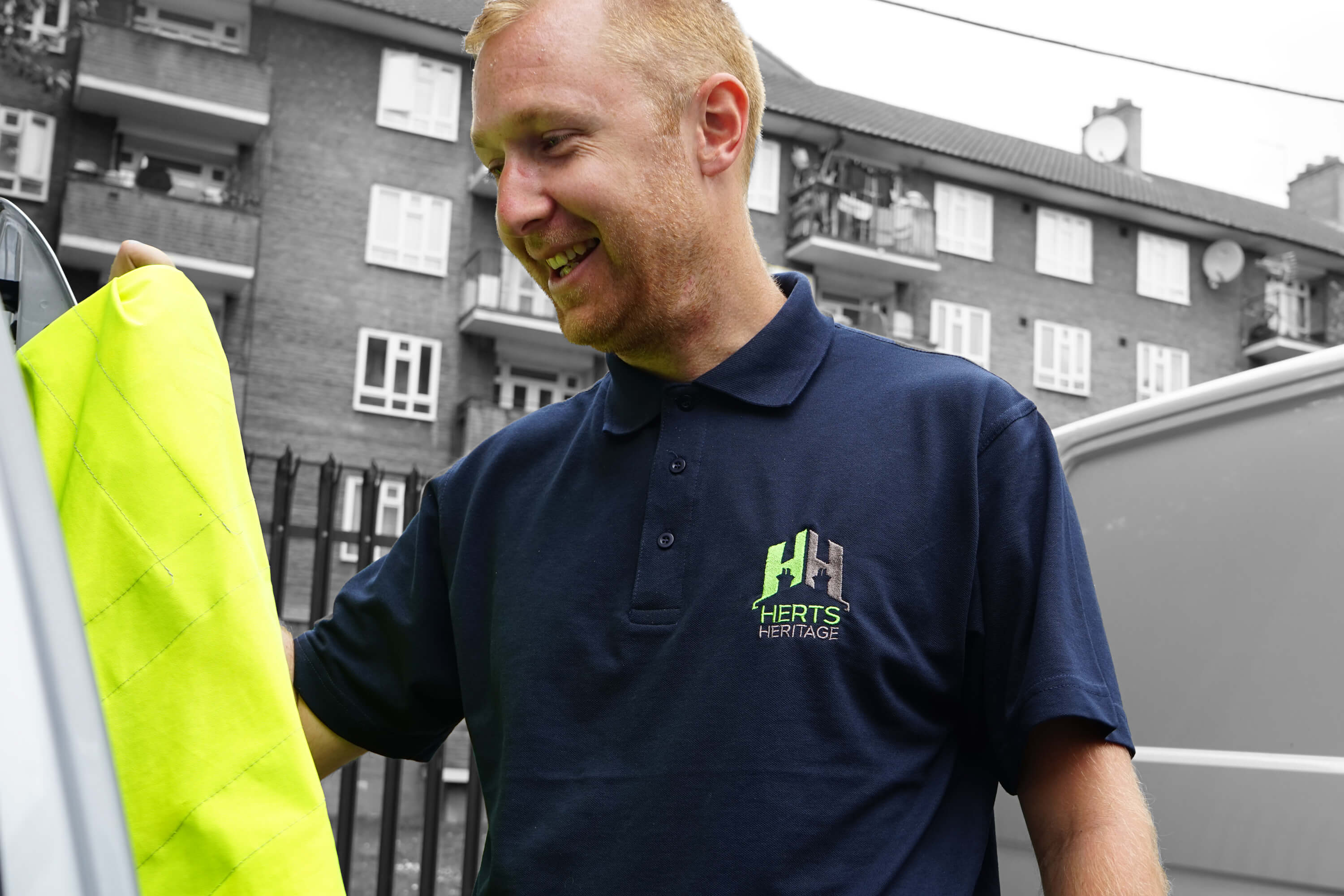 A Herts Heritage employee wearing a new shirt with Herts Heritage rebrand design