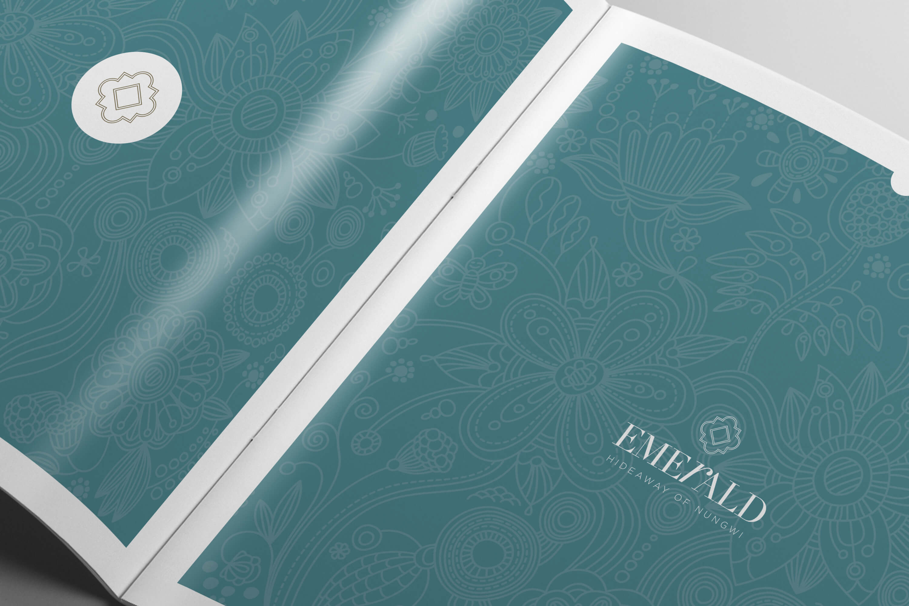 Open copy of the JLL Emerald Resorts corporate brochure showing pattern detail