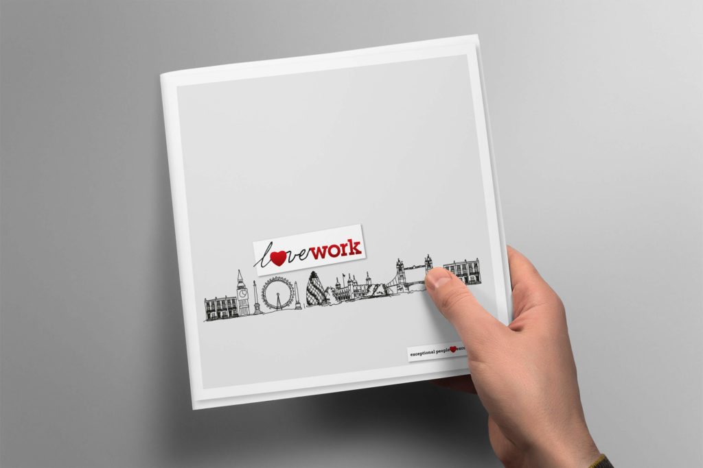 Hand holding a copy of the Lovework brochure showing the cover design