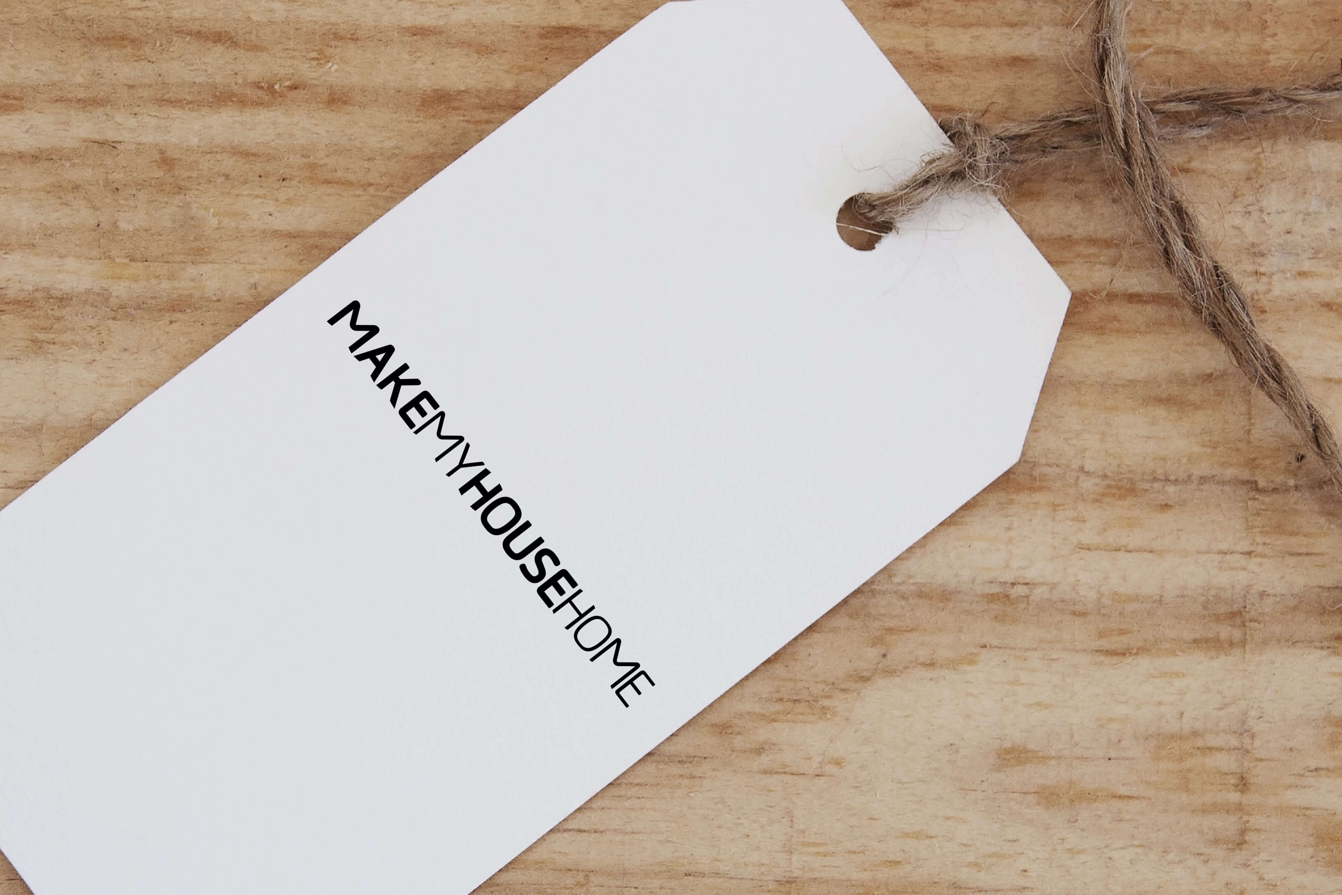 A paper tag showing the Make My House Home logotype only