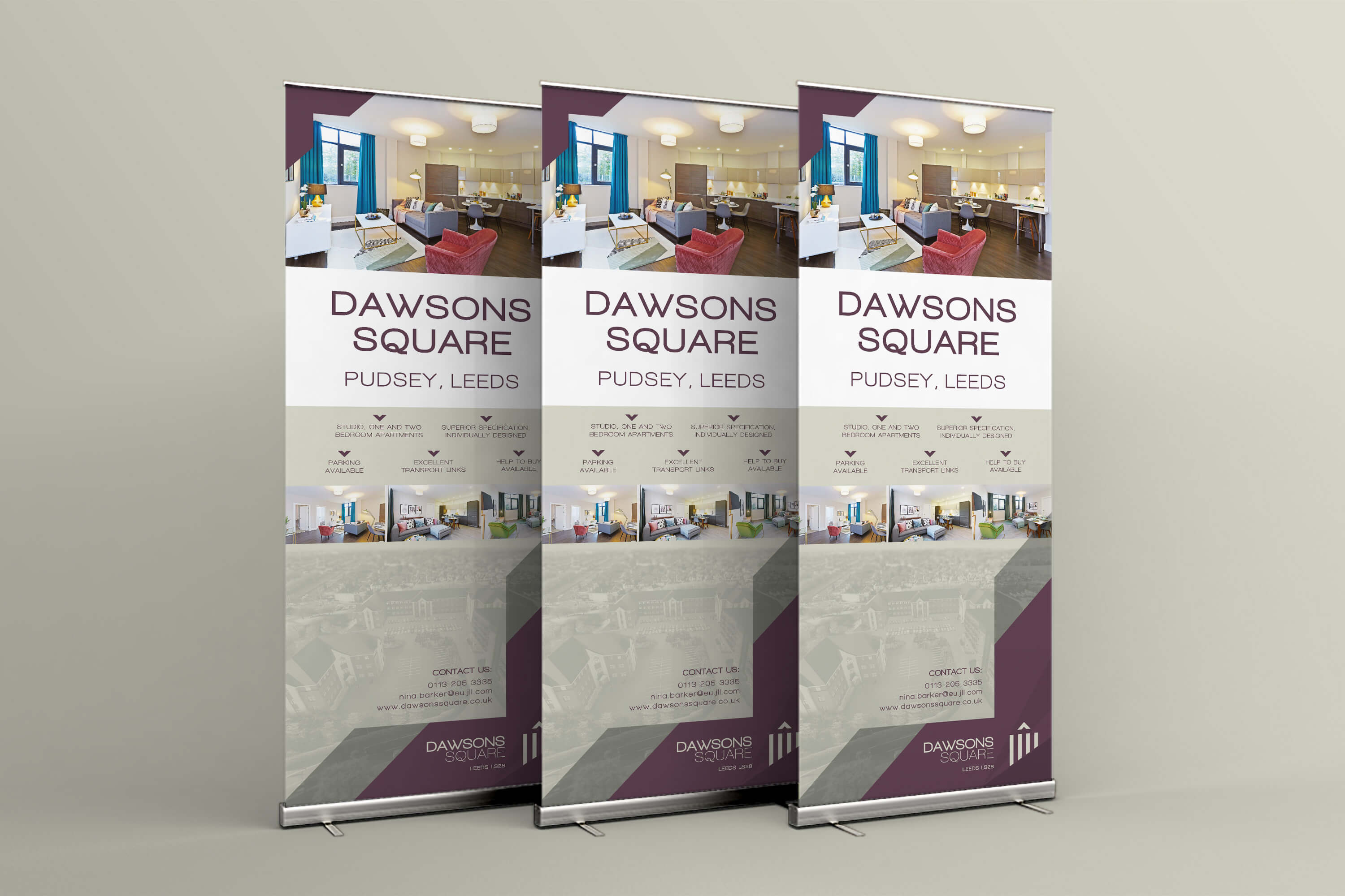 A group of three roller banners with Dawsons Square branding and marketing