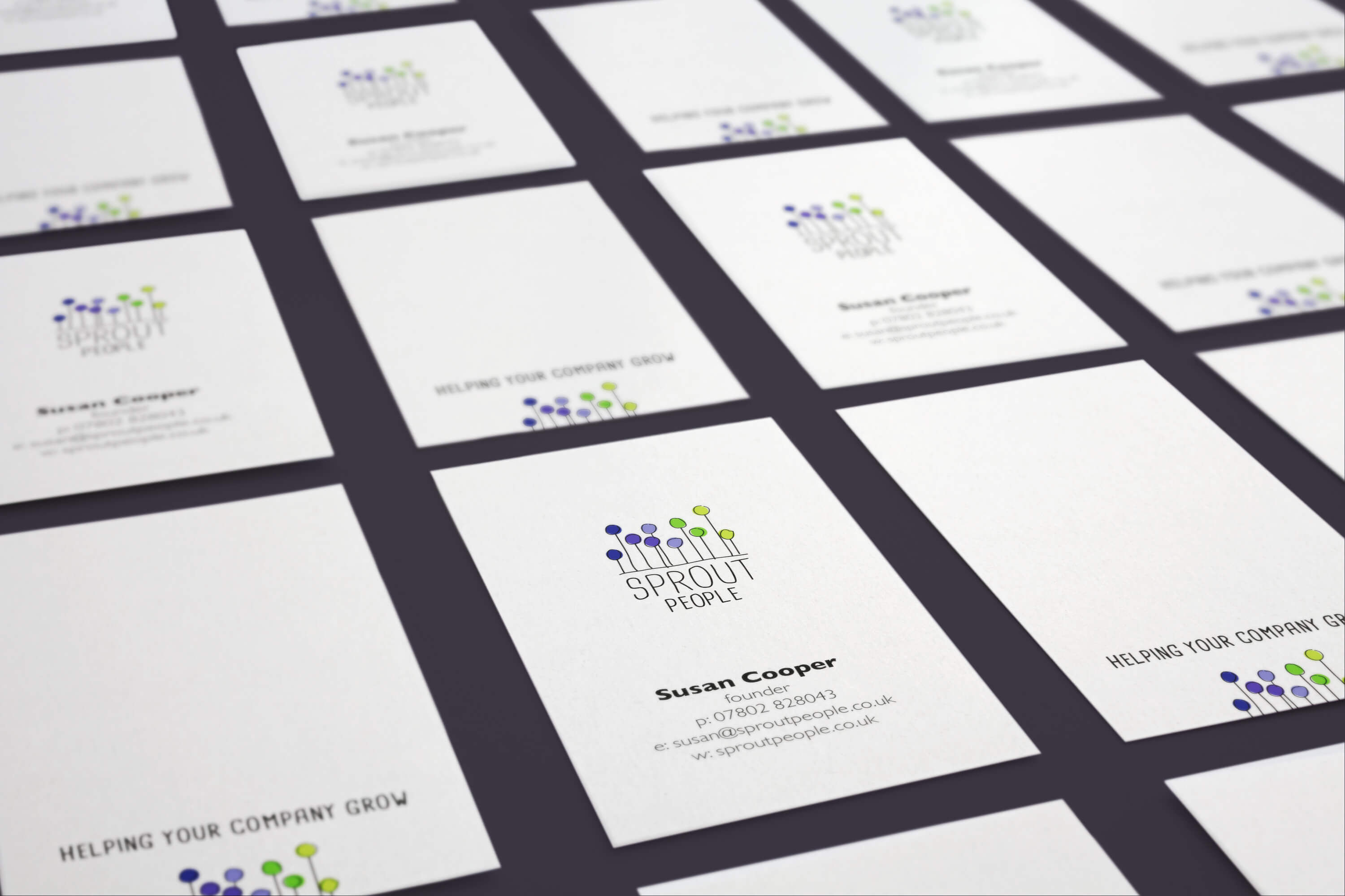 Multiple cards displaying the Sprout People brand identity on the front and back of business cards